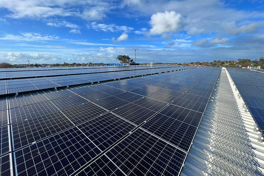 Rows of solar panels on the roof of the Mount Gambier recreation centre under a blue sky